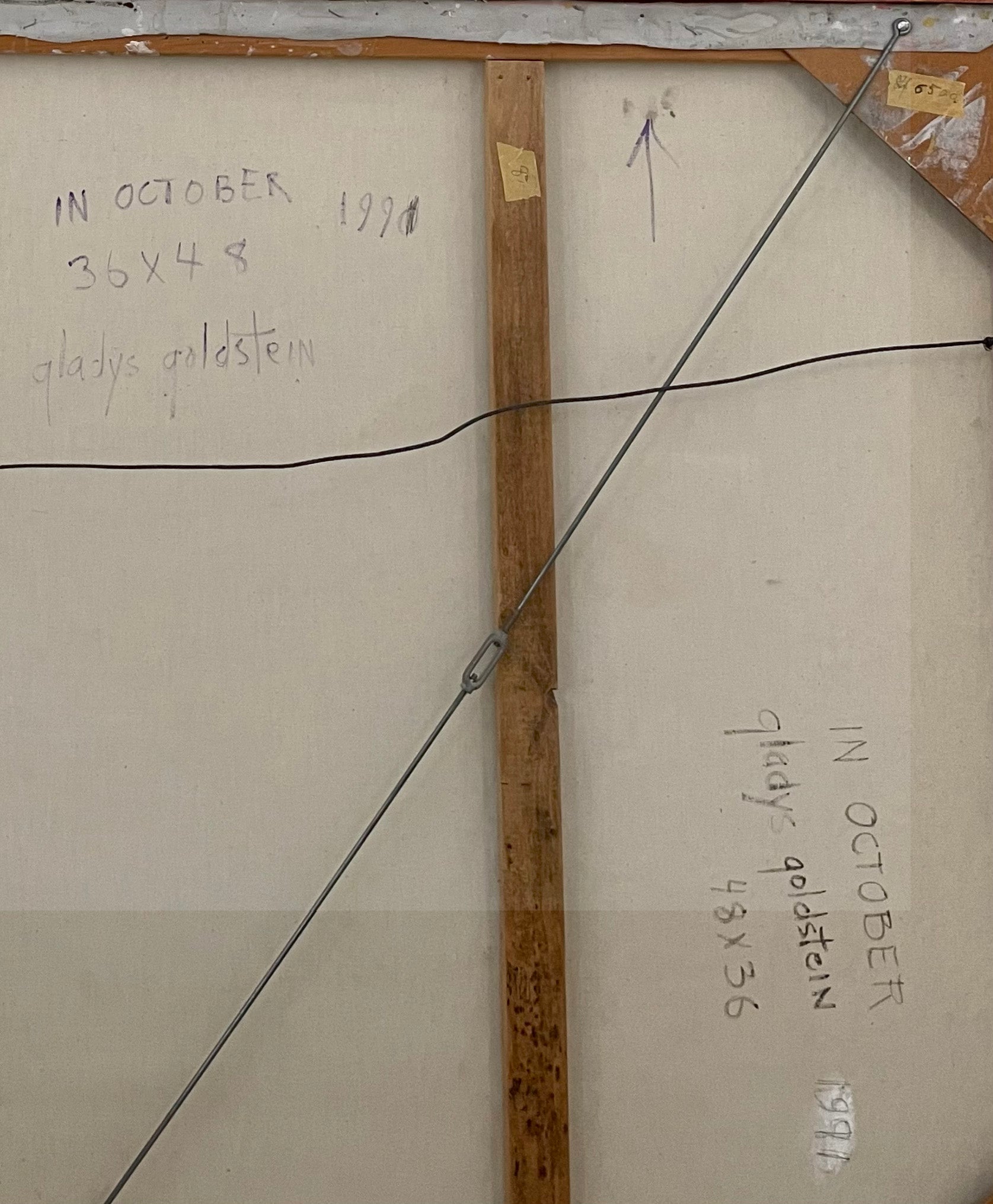 Back of a painting with measurements and artist's name
