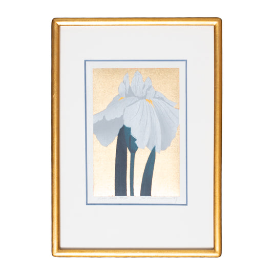Framed artwork of a white flower with a gold frame on a white background