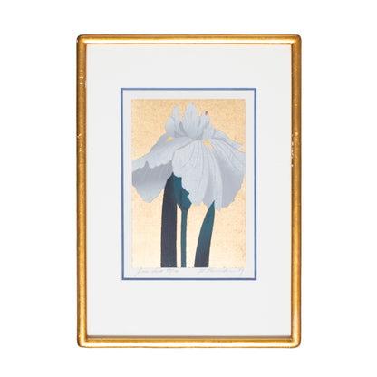 Framed artwork of a floral design with a gold frame on a white background